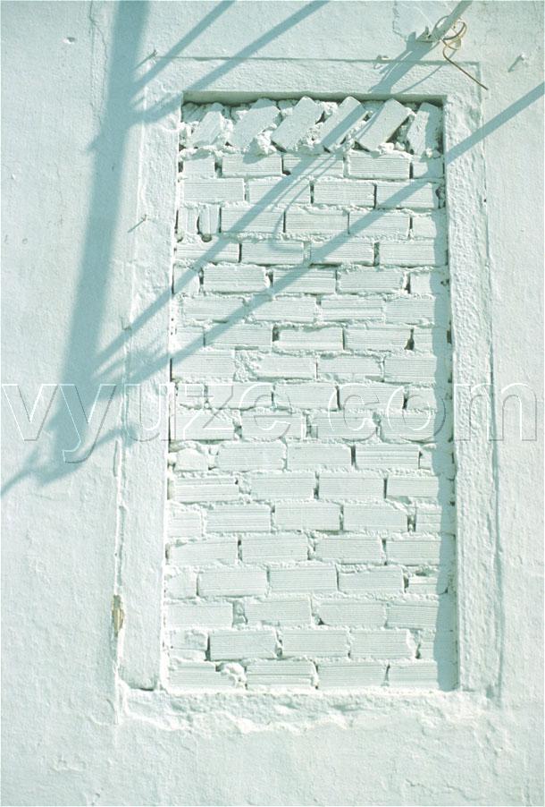 Bricked-up window and shadows / Location: Greece
