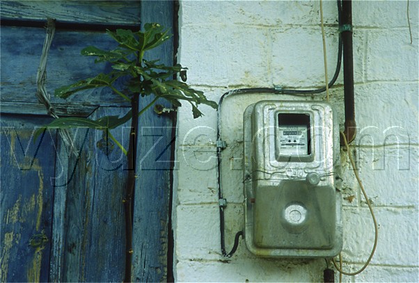 Electricity meter and blue door / Location: Greece