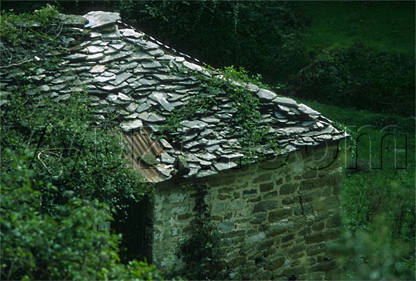 Rock and corrugated iron roof / Location: Greece